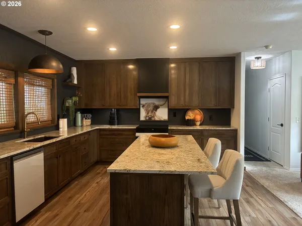 a kitchen with a table chairs sink and cabinets