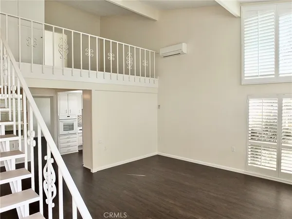 a view of a livingroom with furniture and hardwood floor