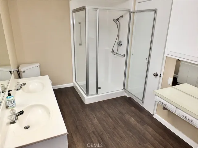 a bathroom with a sink a toilet and shower