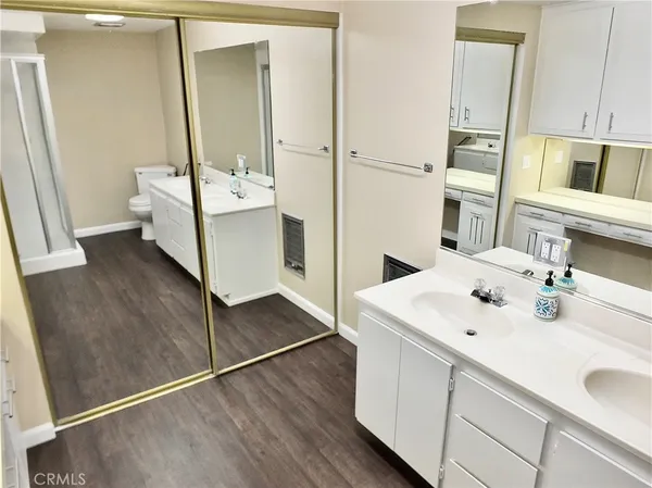 a white toilet sitting next to a white wall