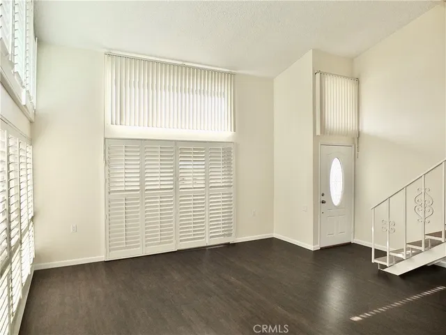 an empty room with cabinet and a ceiling fan