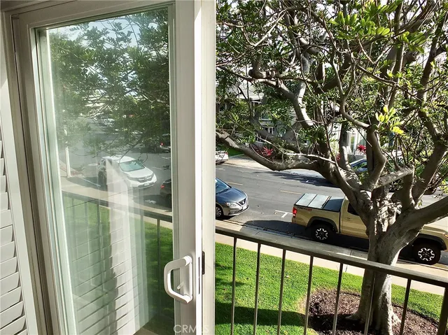 a view of a patio with table and chairs under an umbrella