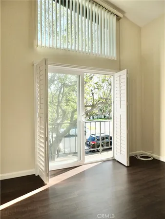 a view of a patio with table and chairs under an umbrella