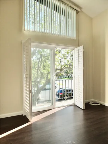 a front view of a house with garden and trees