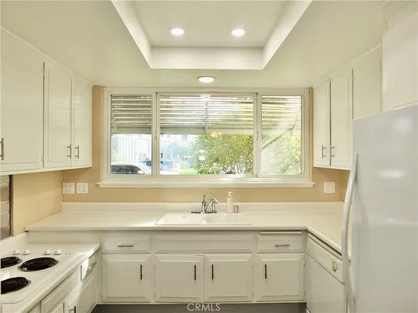 an empty room with cabinet and a ceiling fan