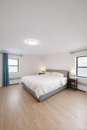 a bedroom with a bed and windows