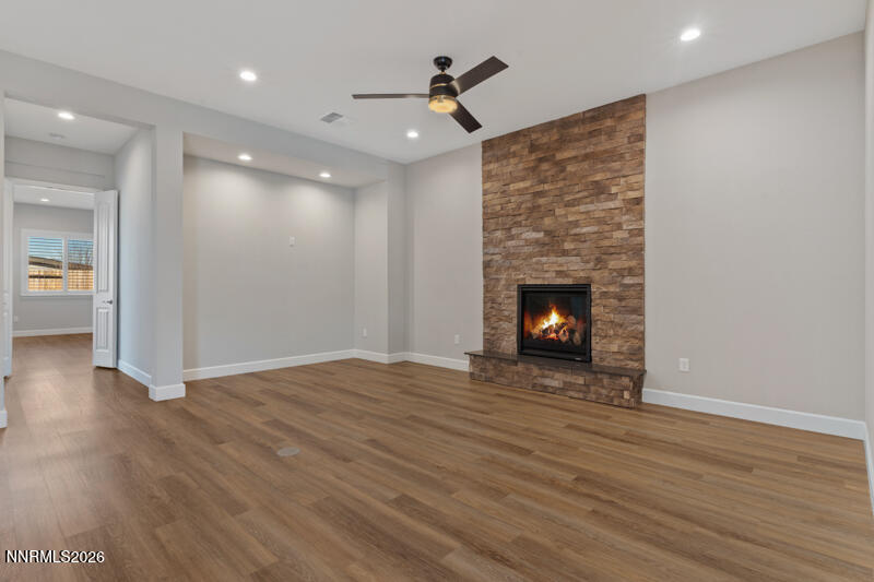 2221 Paint Horse Drive Reno, NV 89521 - Photo 12 of 53 a view of an empty room with wooden floor fireplace and a window