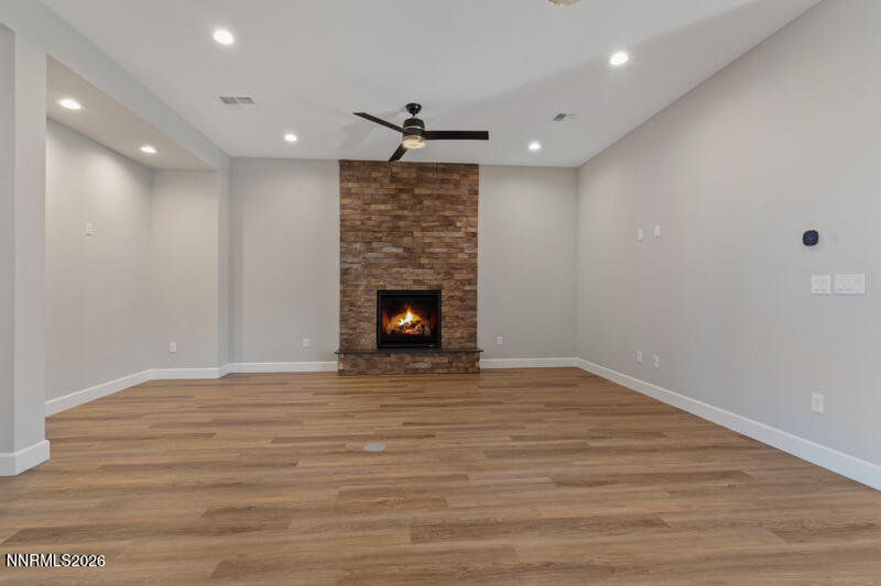 2221 Paint Horse Drive Reno, NV 89521 - Photo 13 of 53 a view of an empty room with wooden floor fireplace and a window