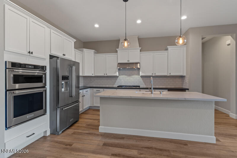 2221 Paint Horse Drive Reno, NV 89521 - Photo 15 of 53 a kitchen with kitchen island a sink stainless steel appliances and cabinets