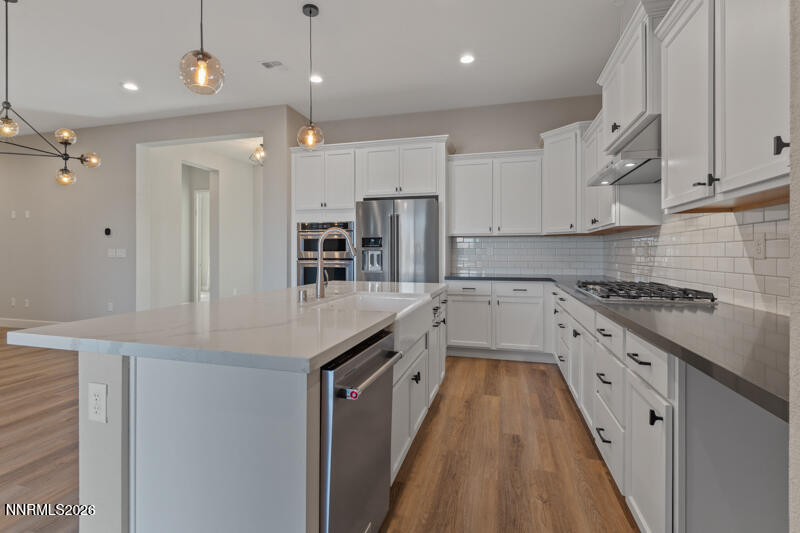 2221 Paint Horse Drive Reno, NV 89521 - Photo 16 of 53 a kitchen with kitchen island granite countertop a sink a counter top space stainless steel appliances and cabinets