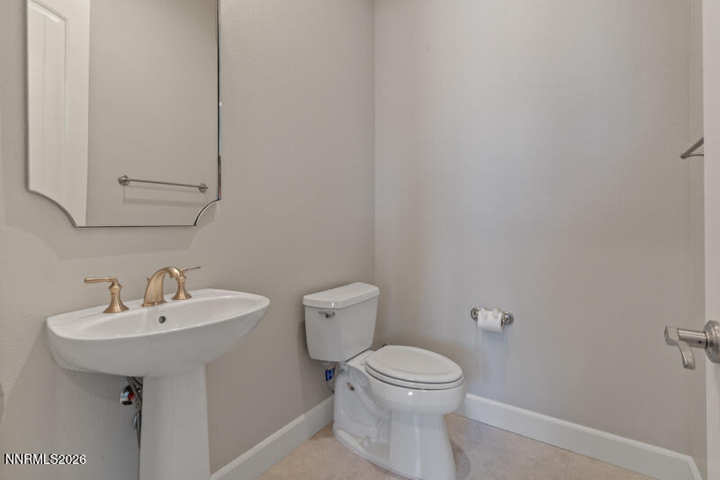 2221 Paint Horse Drive Reno, NV 89521 - Photo 26 of 53 a bathroom with a sink a toilet and mirror