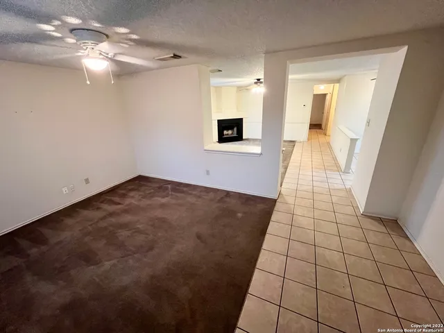 a view of a livingroom with an empty space a sink wooden floor and chandelier