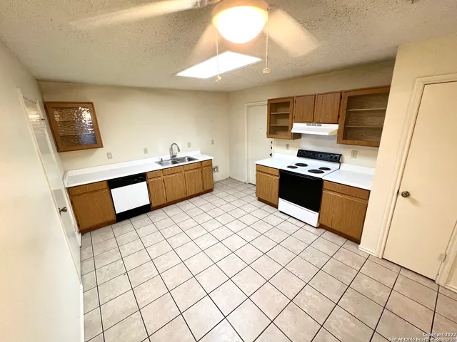 a kitchen with stainless steel appliances a stove a sink and a refrigerator