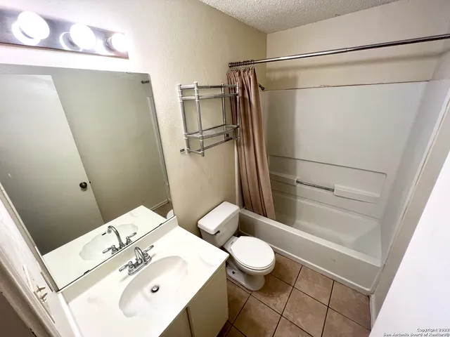 a bathroom with a sink mirror vanity and toilet