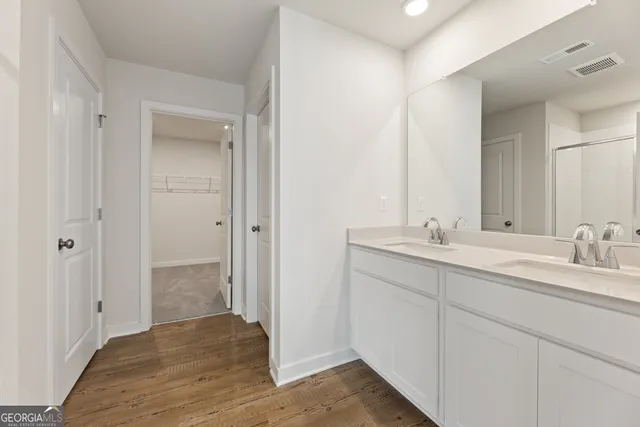 a bathroom with a glass shower door