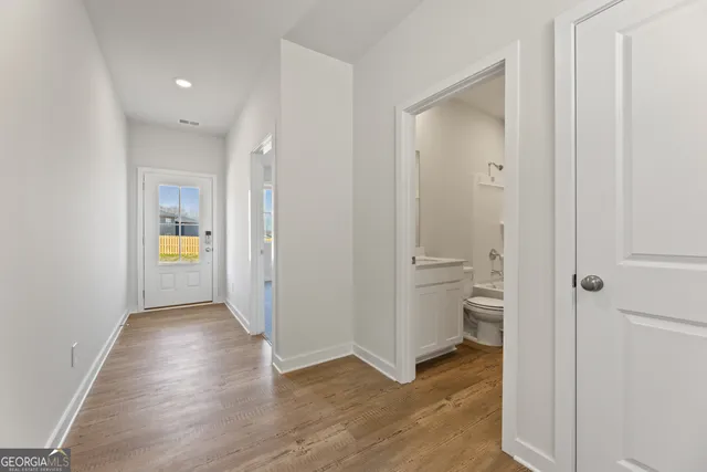 a bathroom with a sink toilet vanity and shower