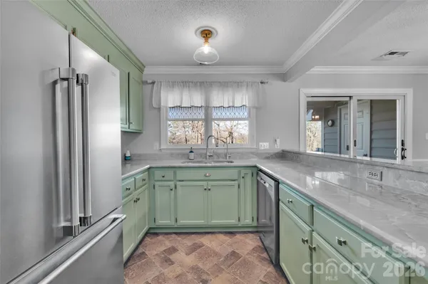 a kitchen with a sink and a refrigerator
