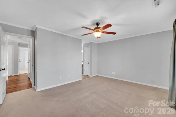 a view of an empty room with a fan