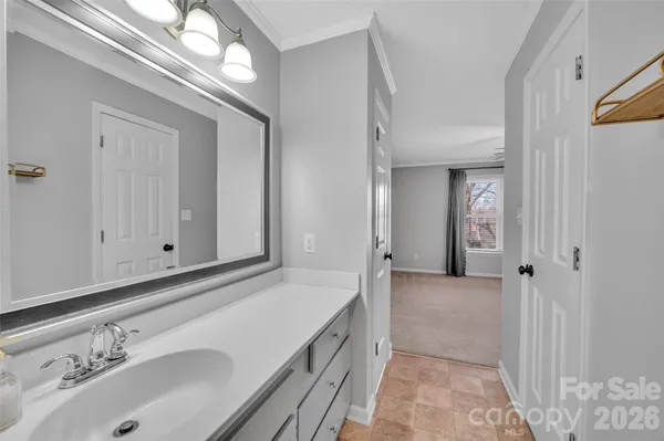 a bathroom with a sink a vanity and a mirror