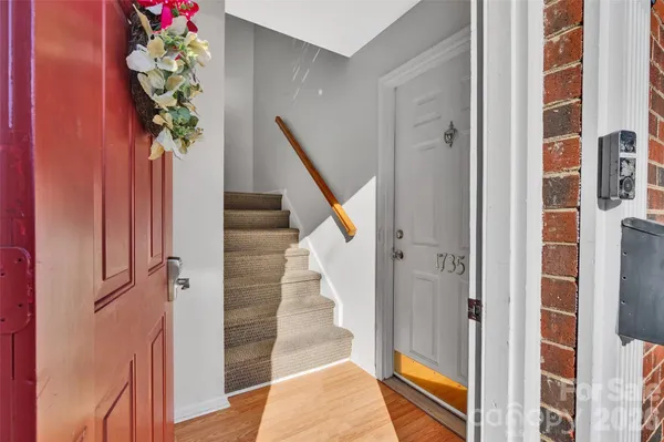 a view of staircase with wooden floor and a potted plant