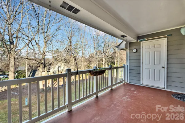 a view of a porch with wooden floor and fence