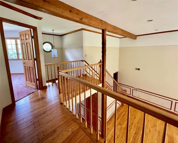 a view of an entryway wooden floor and stairs