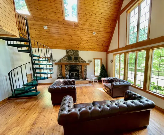 a living room with furniture fireplace and a large window