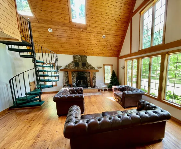 a living room with furniture fireplace and a large window