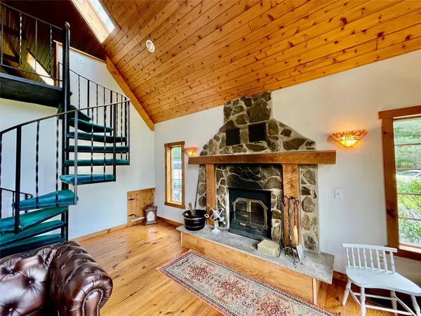 a view of a livingroom with furniture and a fireplace