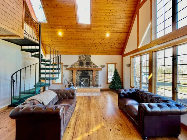 a living room with furniture fireplace and a large window
