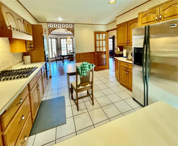 a kitchen with stainless steel appliances a stove a sink and a refrigerator