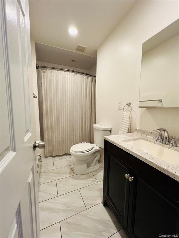 93 Main Street Garnerville, NY 10923 - Photo 13 of 15 a bathroom with a double vanity sink toilet and a mirror