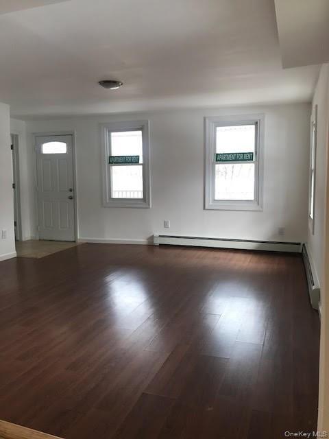 93 Main Street Garnerville, NY 10923 - Photo 3 of 15 an empty room with wooden floor and windows