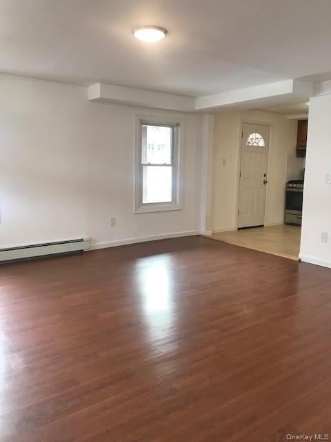 93 Main Street Garnerville, NY 10923 - Photo 4 of 15 an empty room with wooden floor and windows