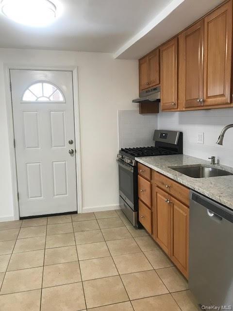 93 Main Street Garnerville, NY 10923 - Photo 5 of 15 a kitchen with stainless steel appliances granite countertop a stove a sink and a white cabinets