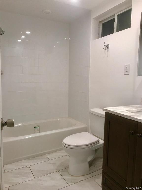 93 Main Street Garnerville, NY 10923 - Photo 10 of 15 a bathroom with a toilet a sink and bathtub