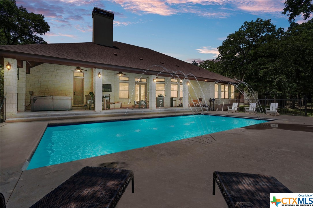 a view of a house with a backyard porch and sitting area