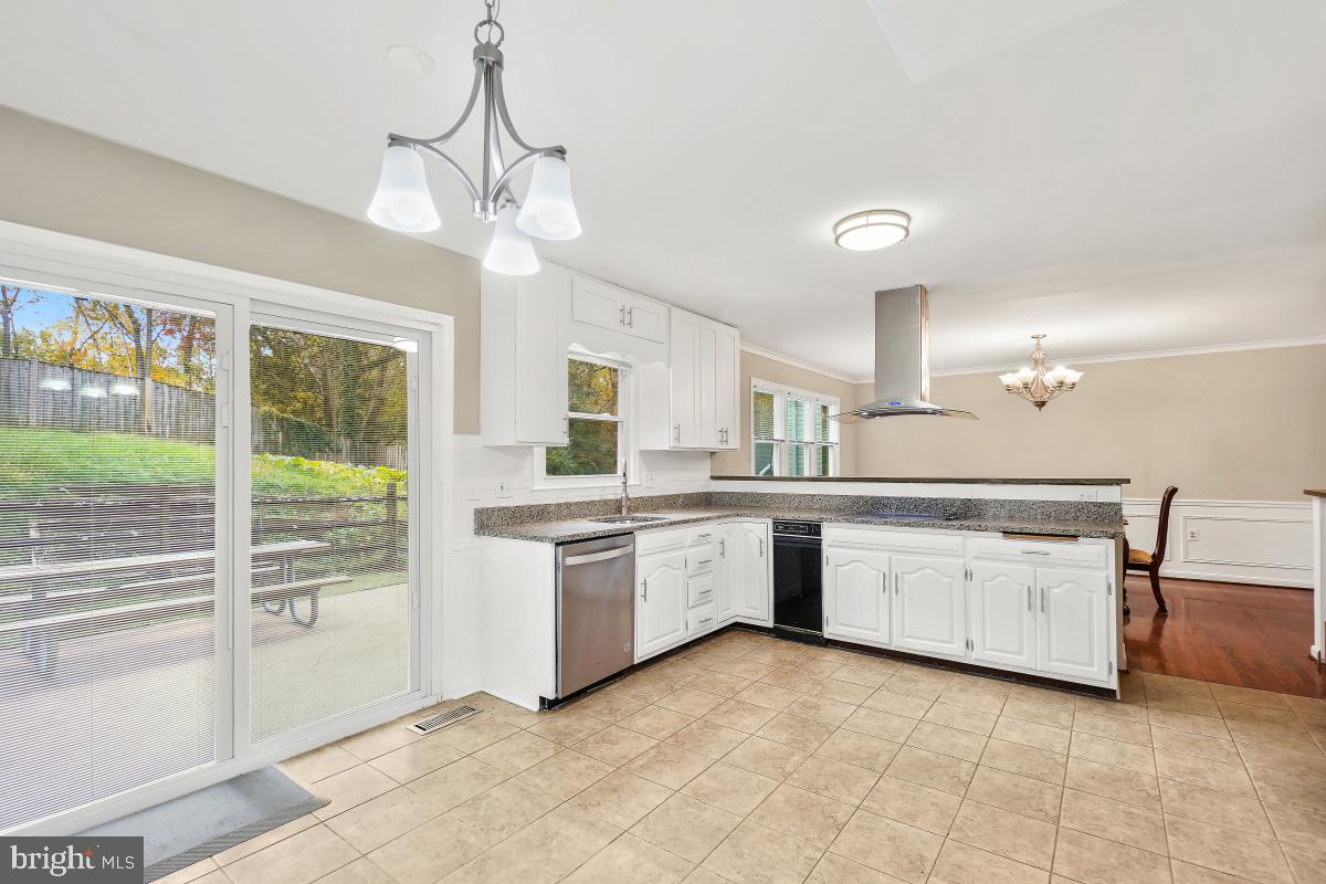 6871 Churchill Road McLean, VA 22101 - Photo 13 of 30 a large kitchen with a large window cabinets and stainless steel appliances