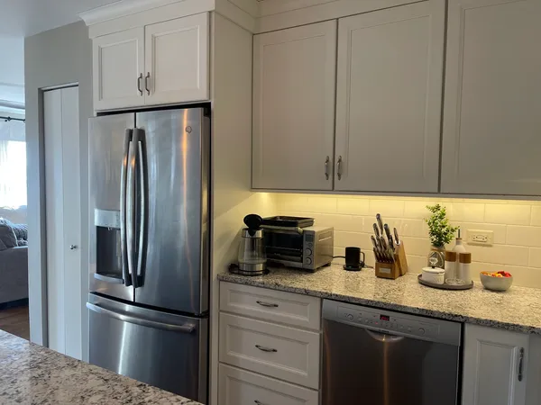 a kitchen with granite countertop a stove and a sink
