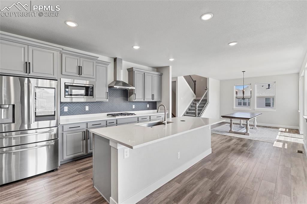 15777 Little Bluestem Road Monument, CO 80132 - Photo 7 of 50 a kitchen with white cabinets and stainless steel appliances