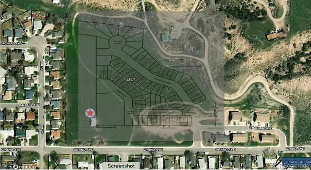 an aerial view of a residential apartment building with a yard and plants