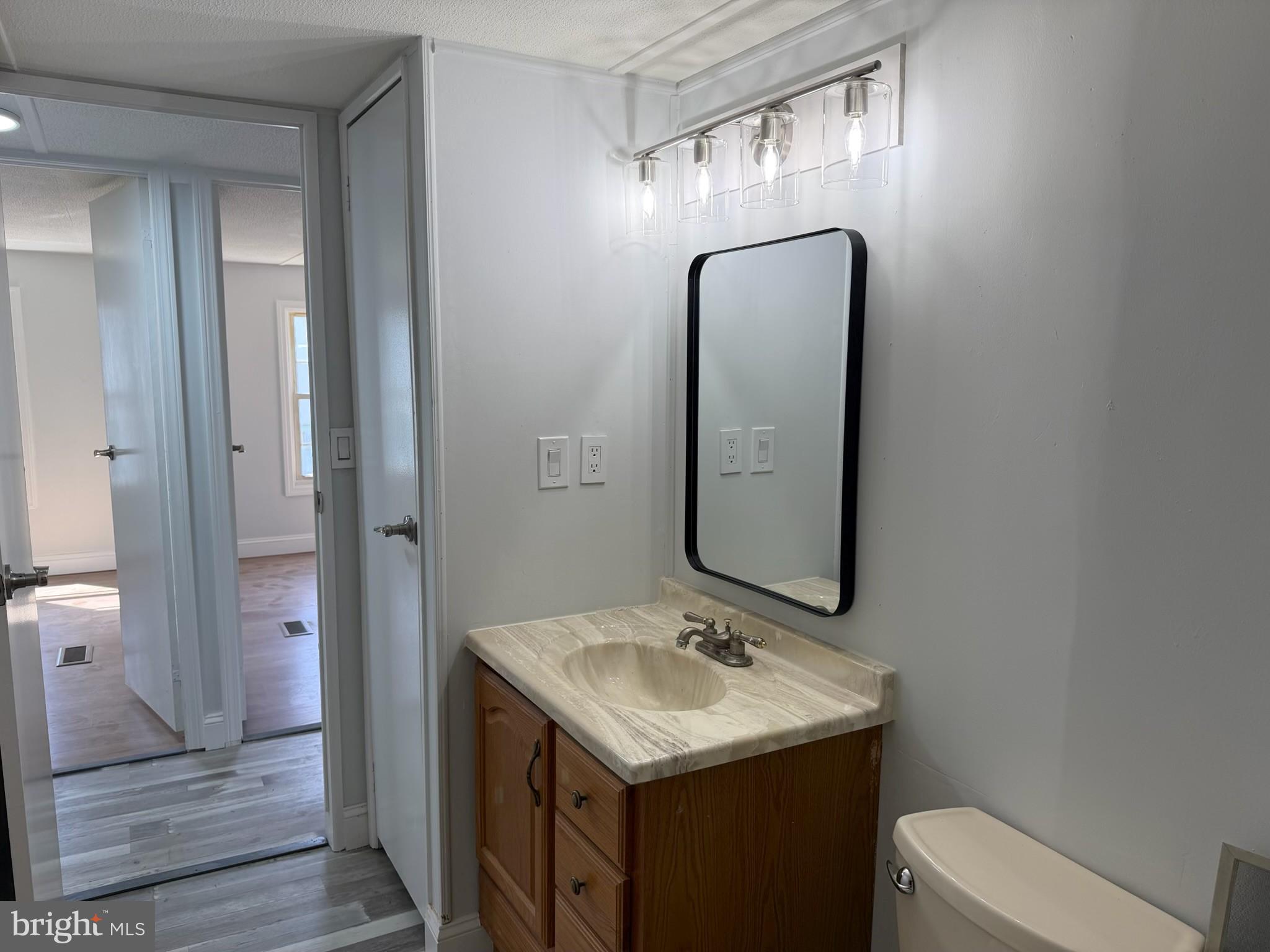 300 Ridge Road, Unit 11 Etters, PA 17319 - Photo 14 of 30 a bathroom with a sink a toilet and mirror