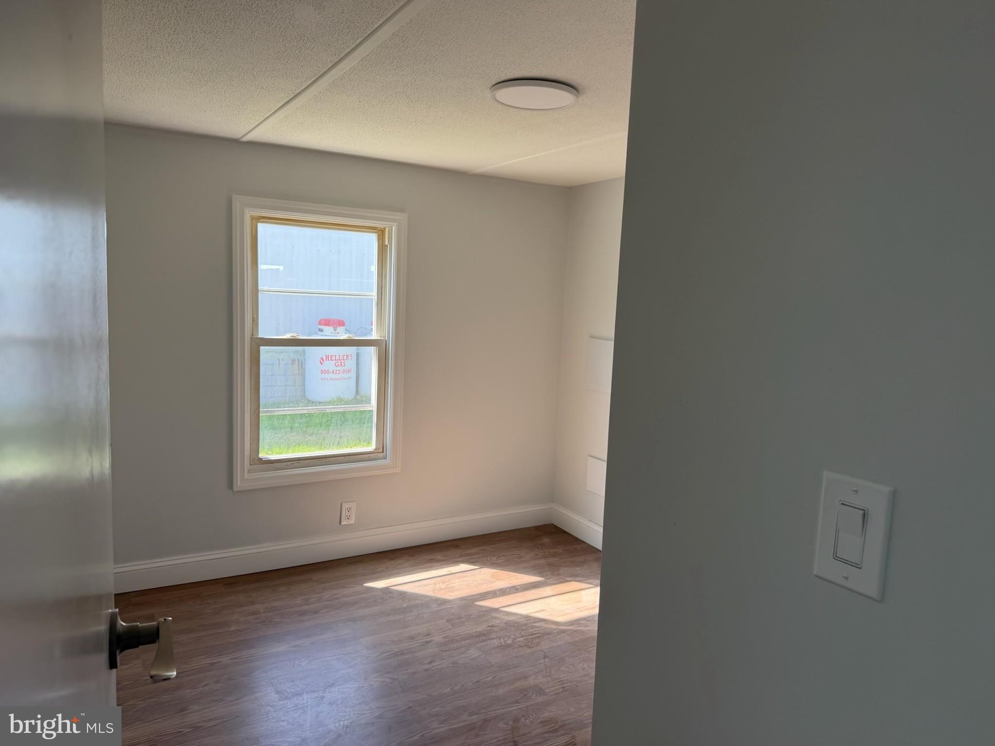 300 Ridge Road, Unit 11 Etters, PA 17319 - Photo 19 of 30 a view of an empty room with wooden floor and a window