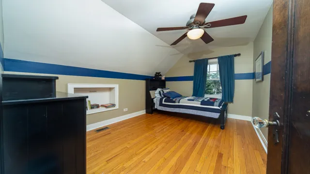 a living room with a couch and a ceiling fan