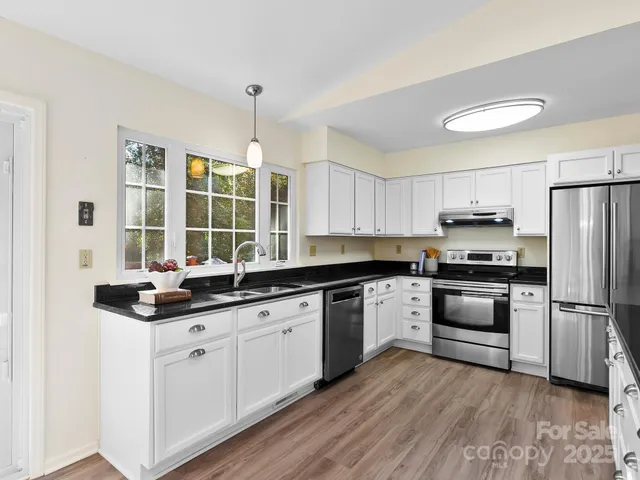 a kitchen with a sink stove and refrigerator