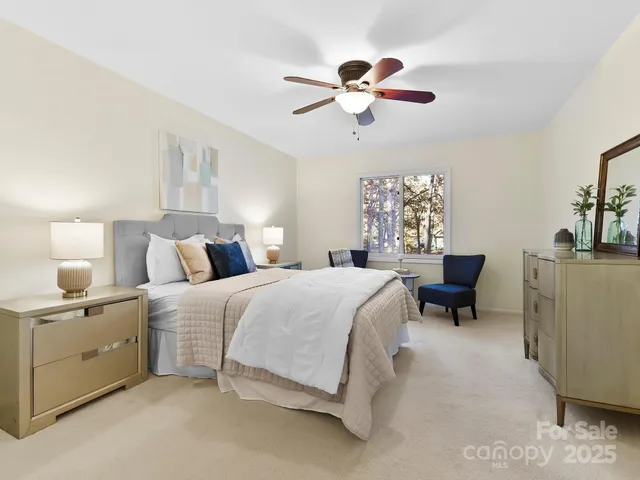 a bedroom with bed and a chandelier