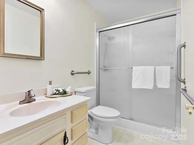 a bathroom with a sink mirror vanity and toilet