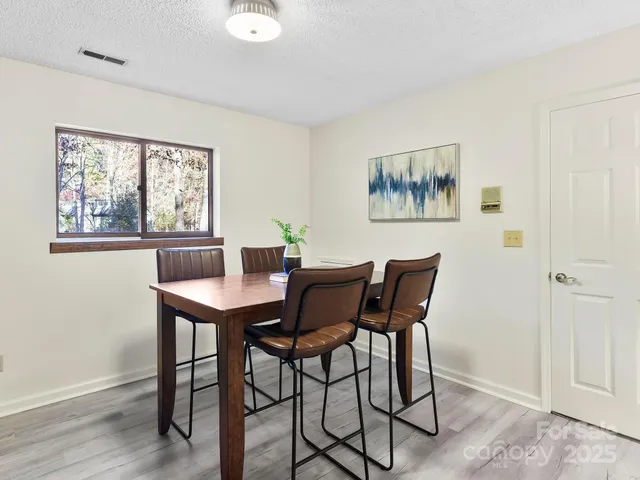 a view of a dining room with furniture and window
