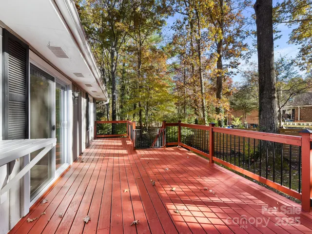 a view of a patio with wooden floor and fence