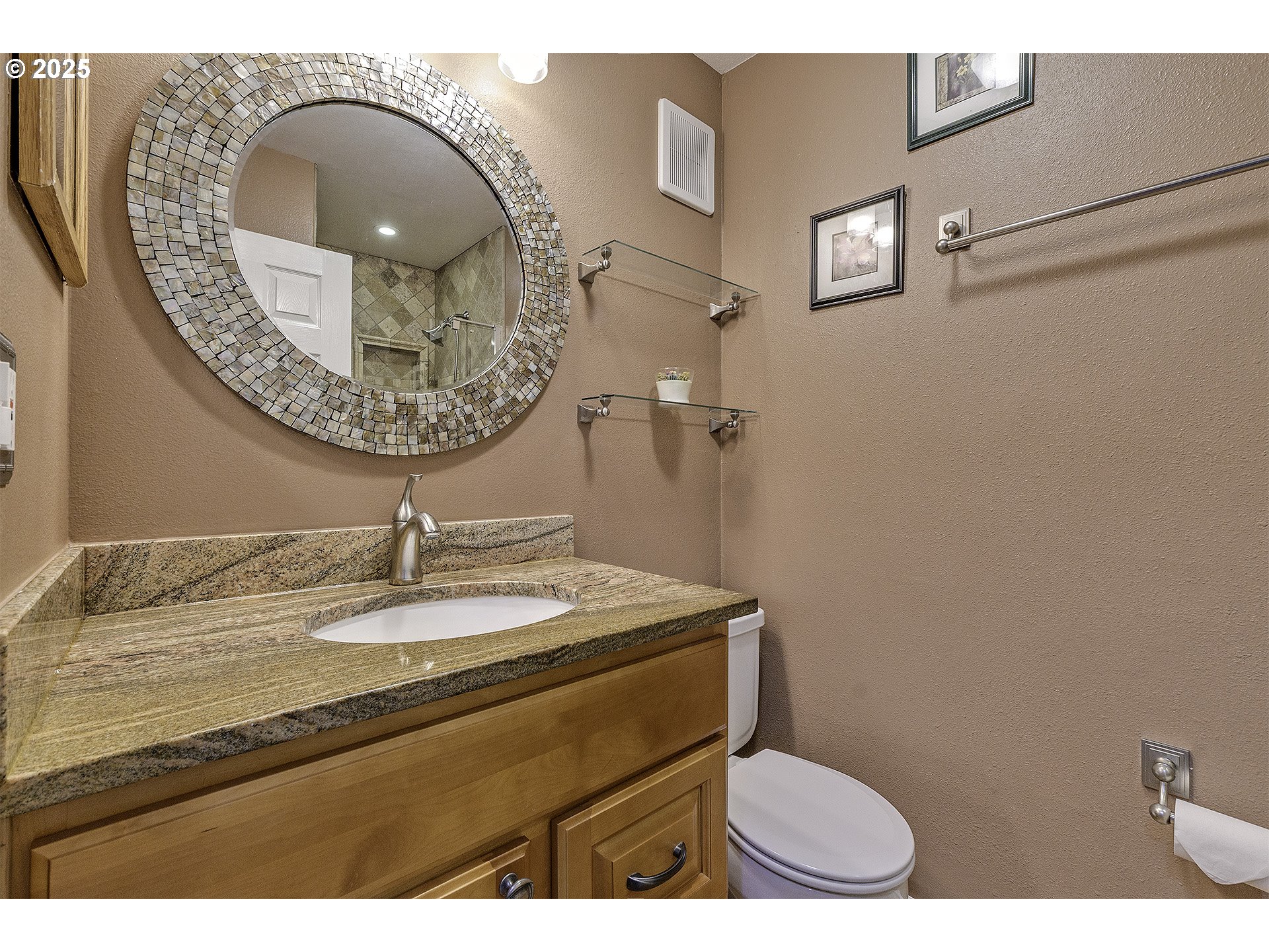 4 Touchstone, Unit 113 Lake Oswego, OR 97035 - Photo 22 of 32 a bathroom with a granite countertop toilet a sink and mirror